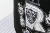 NEW ERA “BLACK HOLE” LAS VEGAS RAIDERS FITTED HAT (BLACK/METALLIC SILVER)